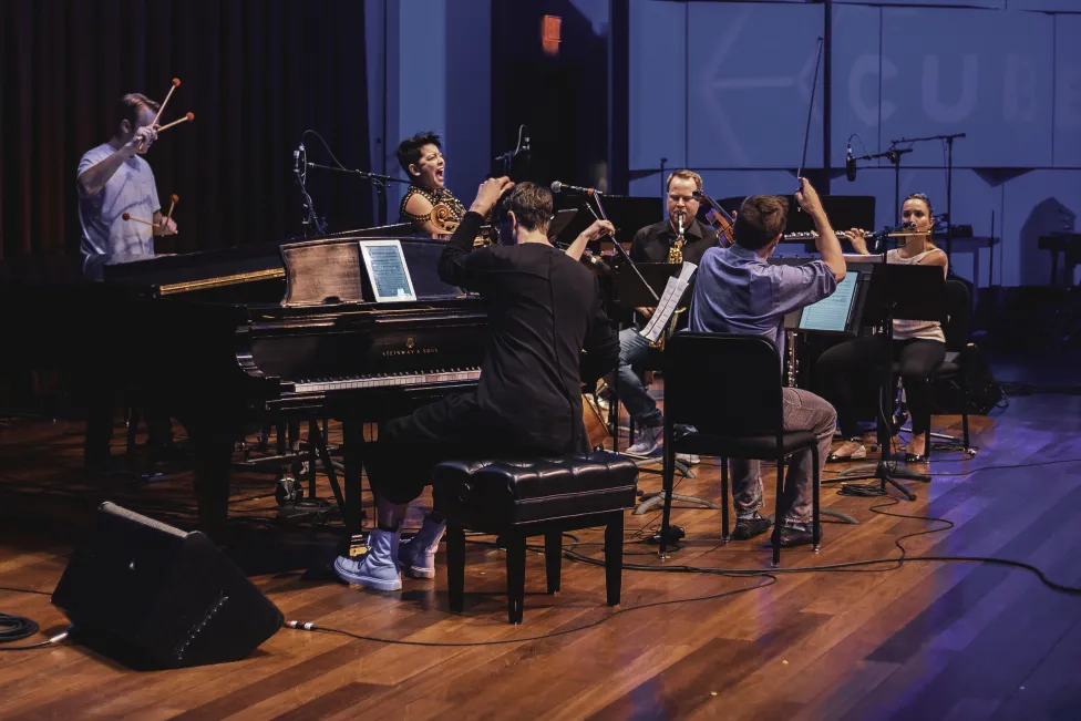 A small orchestra performs on stage
