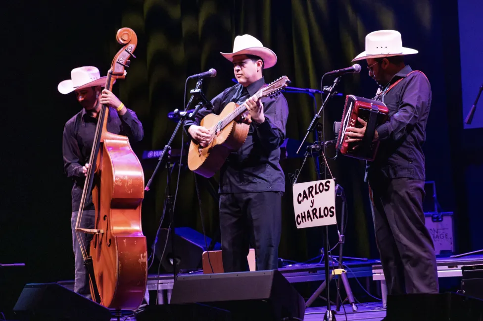 Three people performing on stage