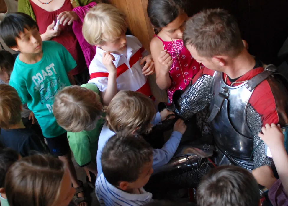 Dr. Jaquet showing children armor in detail
