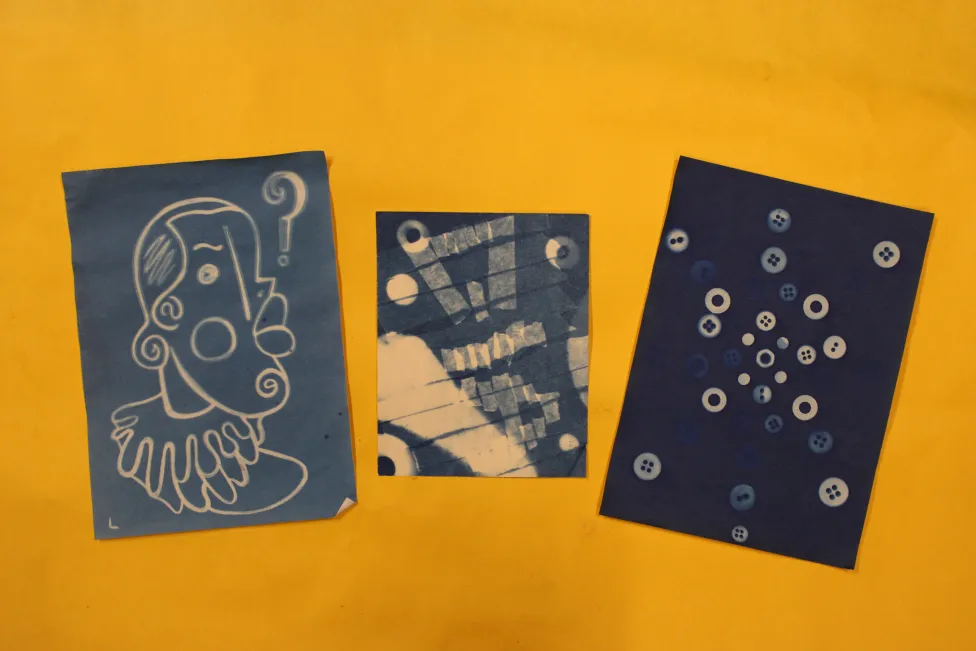 Three Sun Prints,  each eith different white imagery on a blue background