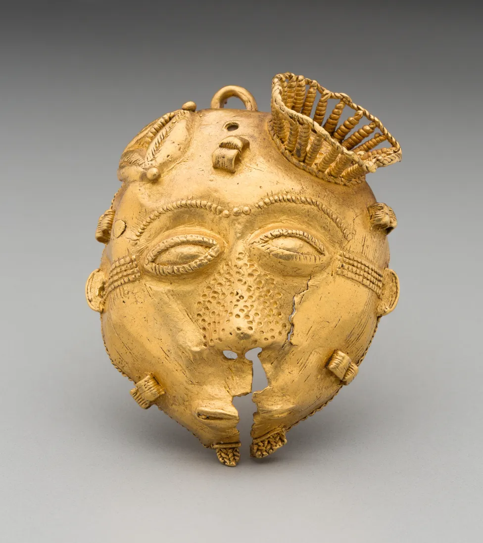 Image of an Akan African ornament depicting a face made of gold.