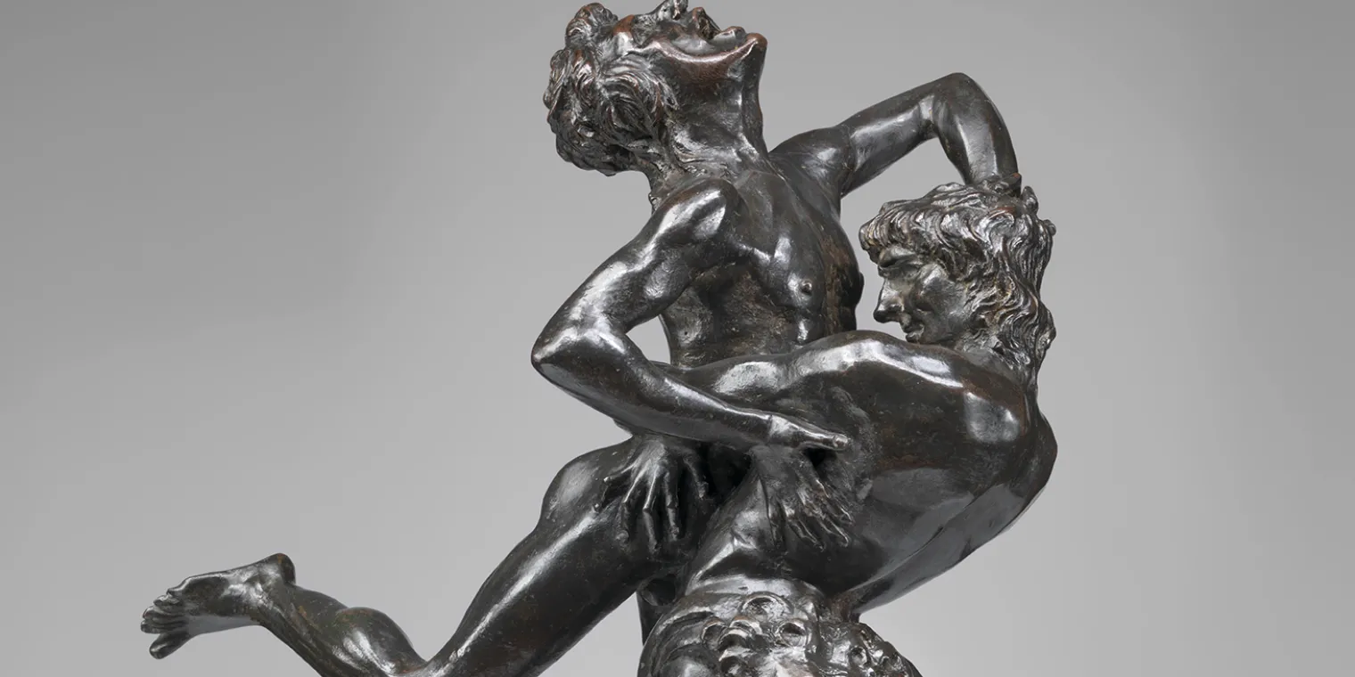 A sculpture featuring two men engaged in a vertical wrestling match by Antonio Del Pollaiolo.