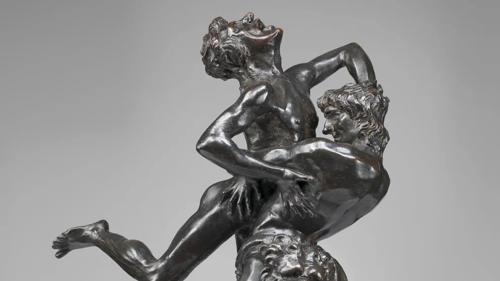 A sculpture featuring two men engaged in a vertical wrestling match by Antonio Del Pollaiolo.