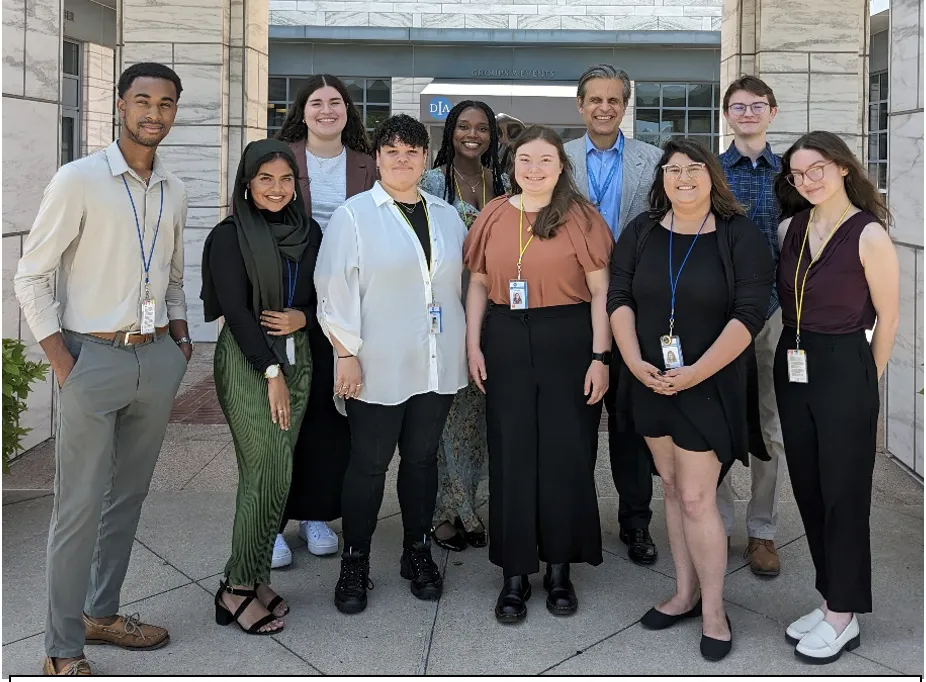 Director standing with Interns