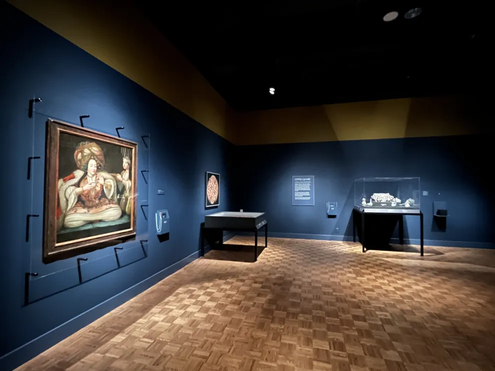 Gallery view of the Detroit Institute of Arts' "Art of Dining" exhibition showing objects and artworks related to coffee culture