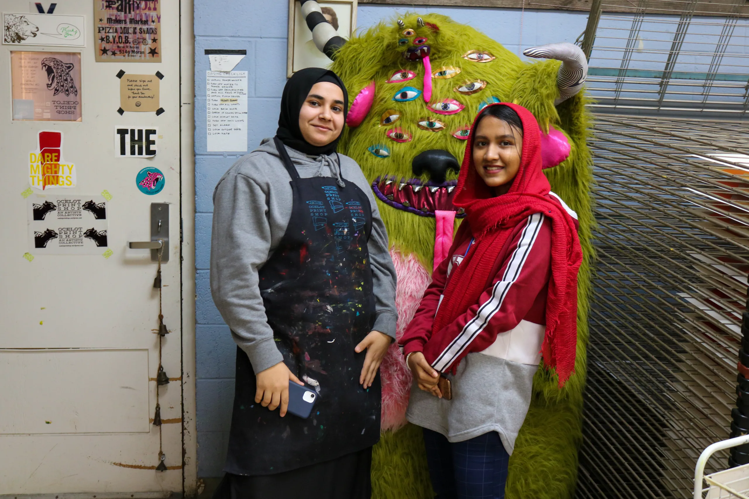 Alzhra and Tasnim pose with a stranger at Ocelot Print Shop.