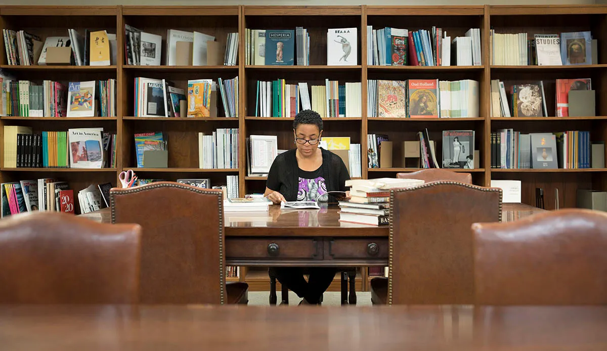 A DIA employee pages through a book in the Research Library