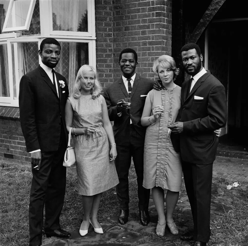 James Barnor (Ghana, b. 1929). A group of friends after the wedding of Mr. and Mrs. Sackey, Balham, London, 1966 (printed 2010–20). Gelatin silver print. Galerie Clémentine de la Féronnière, Paris. © James Barnor, courtesy Galerie Clémentine de la Féronnière, Paris.