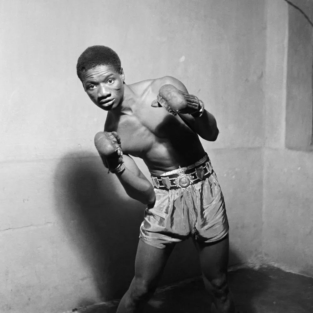 James Barnor (Ghana, b. 1929). Ginger Nyarku wearing the Coronation Belt, Accra, 1953 (printed 2010–20). Gelatin silver print. Autograph, London.