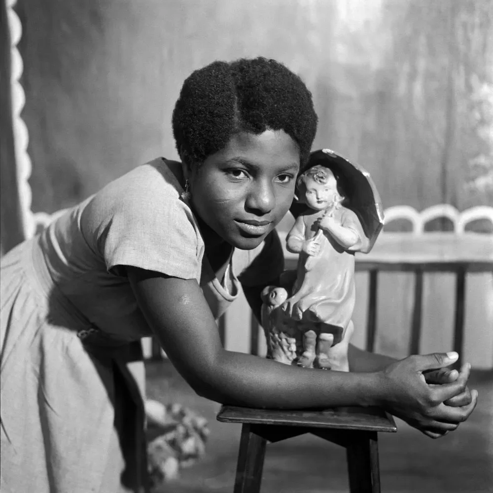 James Barnor (Ghana, b. 1929). Beatrice Okaijah with trademark figurine, Ever Young Studio, Accra, c. 1953 (printed 2010-20). Gelatin silver print. Autograph, London.