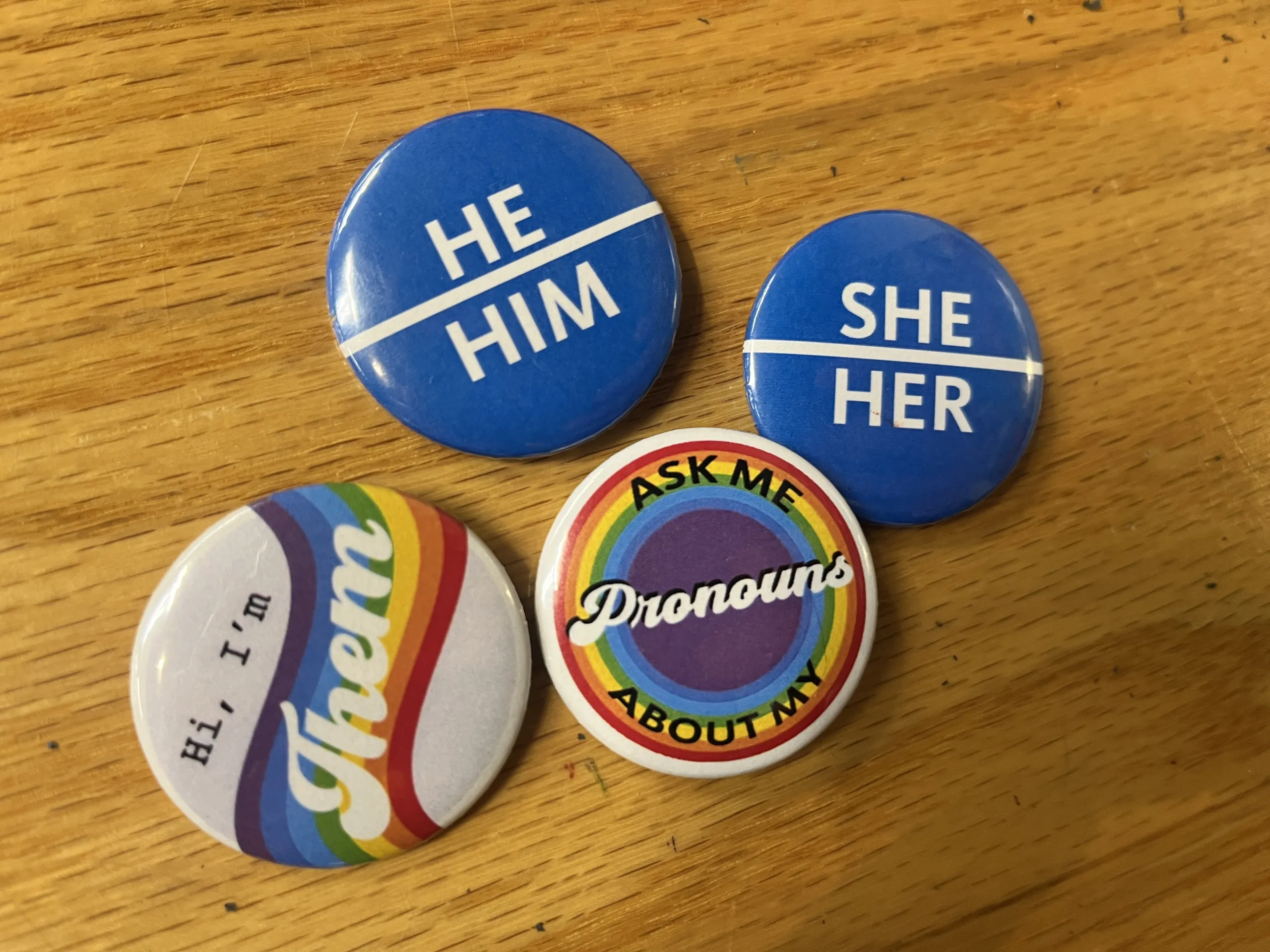 Pronoun pins made by PRISM staff