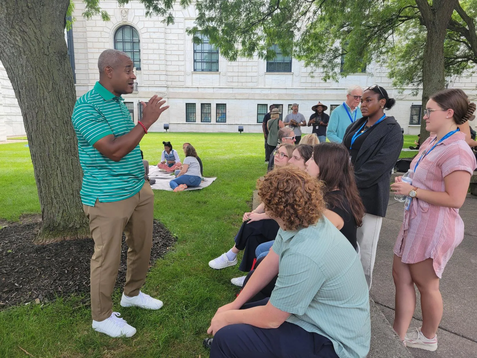 DIA Board Chair Lane Coleman talks to DIA interns at the annual staff picnic in August 2024.