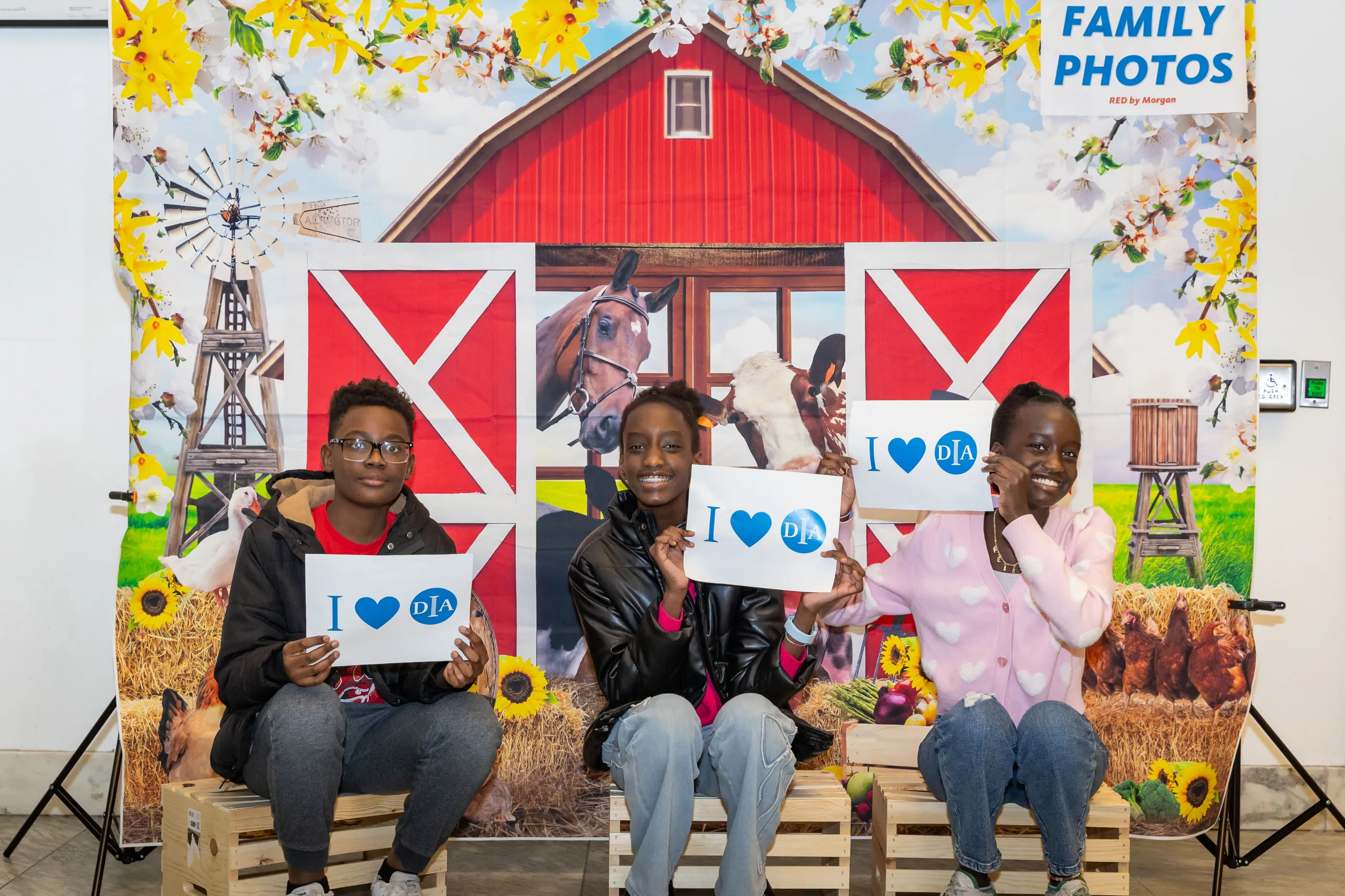 Three kids posing for a photo at a DIA Member Movie Night for Babe.