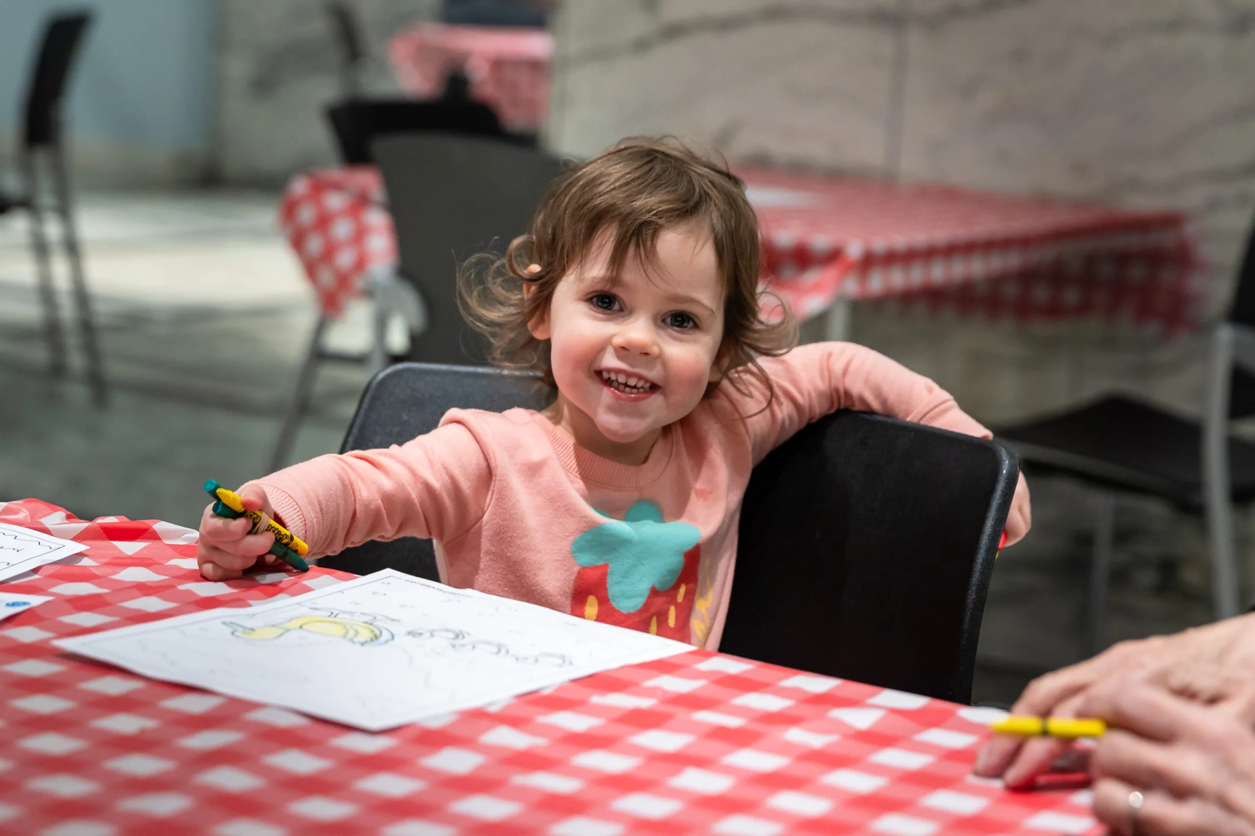 A child smiling at a Member Movie Night experience