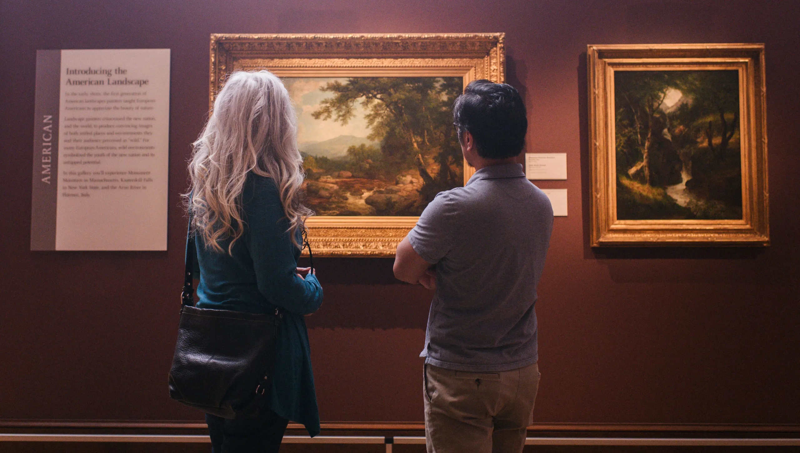 Two visitors looking at art