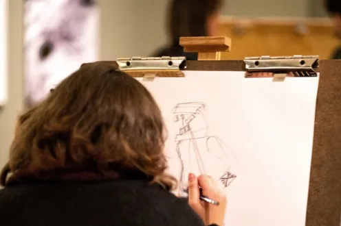 Person sketching on a canvas