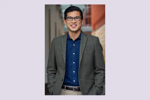 Ian Shin pictured in a gray blazer and dark blue button down shirt with glasses.