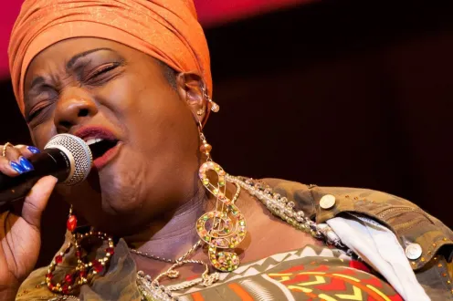 Thornetta Davis singing at a microphone.