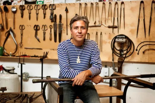 Renowned glass artist Preston Singletary posing with tools