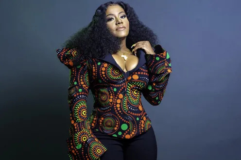 Etana posed in a colorful shirt