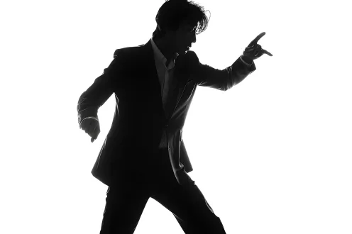 A person in a suit dances