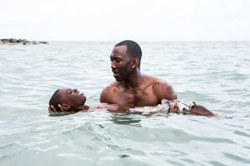 A man holding someone in the water