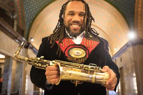 Monford Fisher poses with his saxophone 