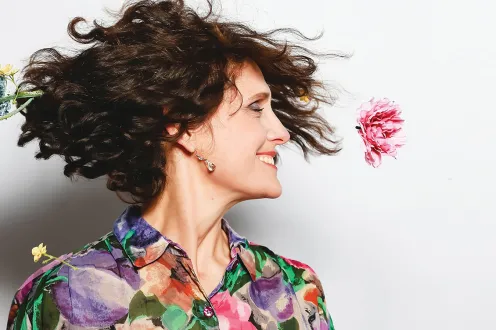 Woman in colorful shirt in the middle of a twirl. 