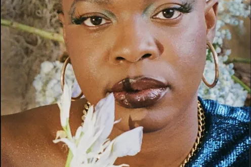 DJ KESSWA poses with a flower