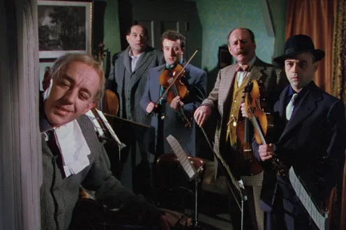 Four men in a string ensemble