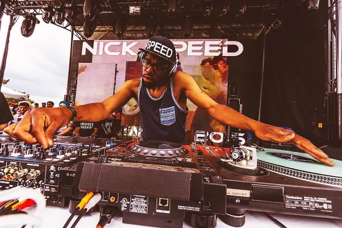 Nick Speed at a DJ table