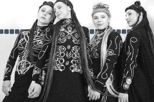 Four women with long, braided hair