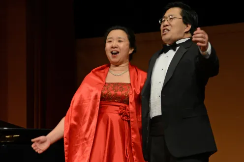 Two people singing on stage