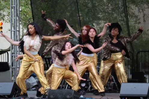 Artlab J's K-pop dance team dancing in matching gold pants