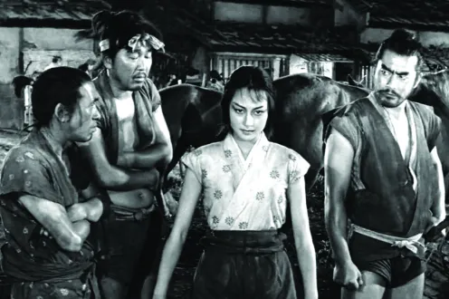 A woman stands proudly between three men