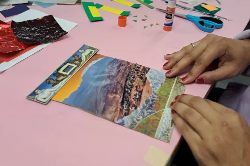 Someone making a mixed-media collage in the DIA's Artmaking Studio