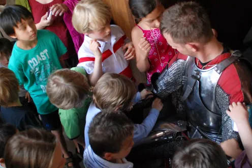 Dr. Jaquet showing children armor in detail