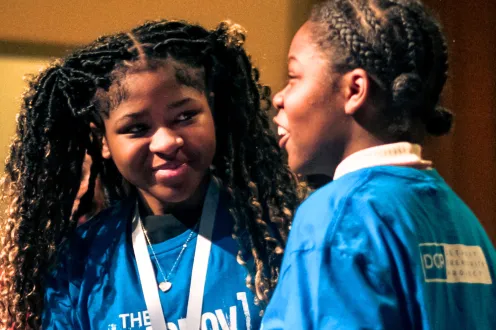 Students on stage at an improv project performance
