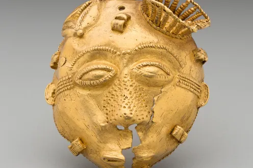 Image of an Akan African ornament depicting a face made of gold.