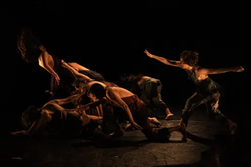 Group of starkly lit dancers