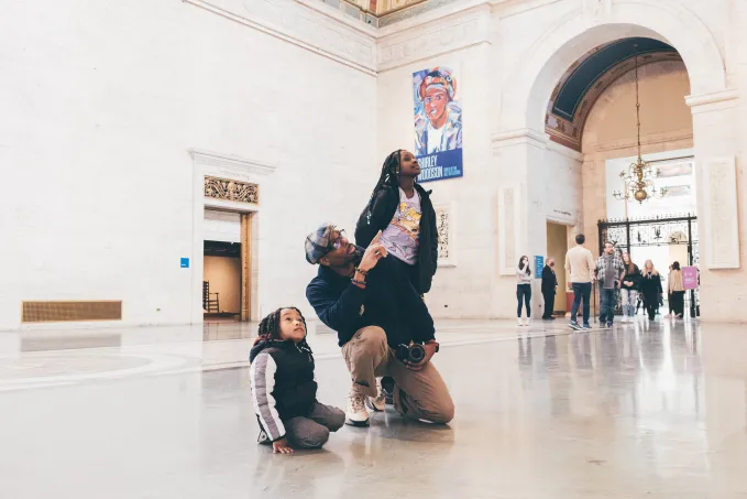 Family looking at art in the museum. 