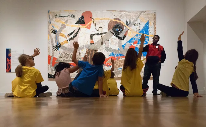 DIA Gallery Teacher asking students on a field trip a question about artwork.