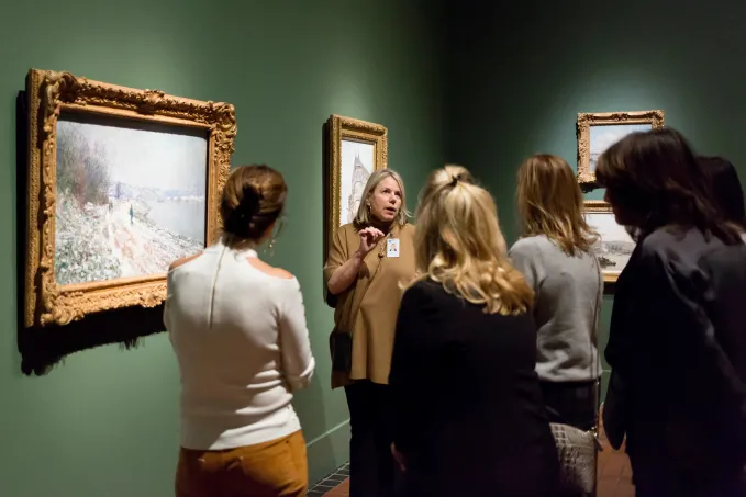 Group of adults touring a museum gallery. 