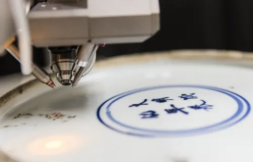 A ceramic piece being scanned by a tool