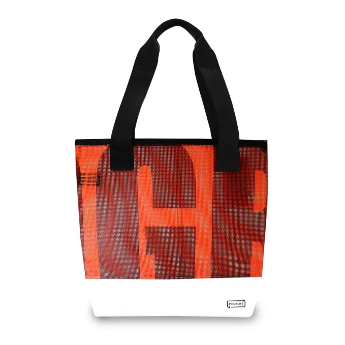This waterproof neon orange tote bag was made from leftover mesh material used for signage on ski slopes. Bright and contemporary, this tote is the ideal, durable accessory for any farmers market, grocery run, or weekend trip.