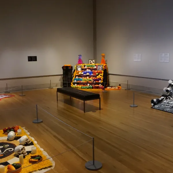 One room of the 2022 Ofrendas exhibition, featuring five Ofrendas altars