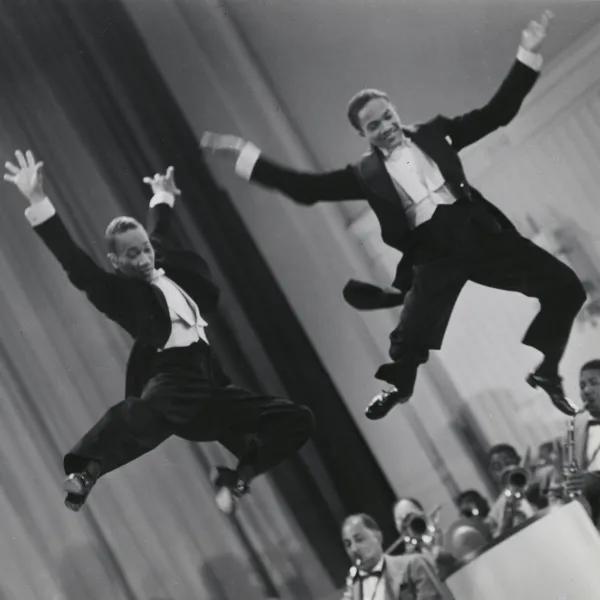 The Nicholas Brothers in a scene from Stormy Weather (1943), from left, Fayard Nicholas and Harold Nicholas. Photographic print, gelatin silver. Courtesy Margaret Herrick Library, ©Twentieth Century