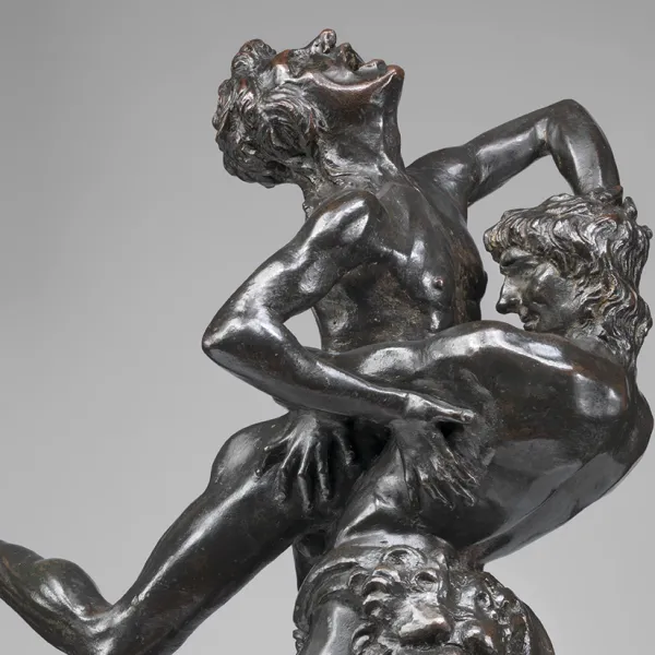 A sculpture featuring two men engaged in a vertical wrestling match by Antonio Del Pollaiolo.