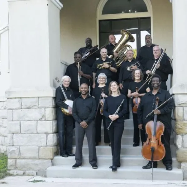 A group of musicians on stone steps