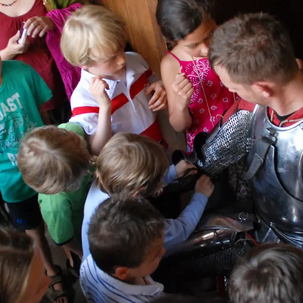 Dr. Jaquet showing children armor in detail